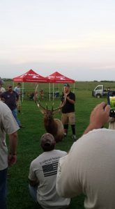 Wounded Veteran pictured with an Elk that he shot.