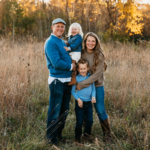 white male, white woman, white little girl and white little boy standing in a field.